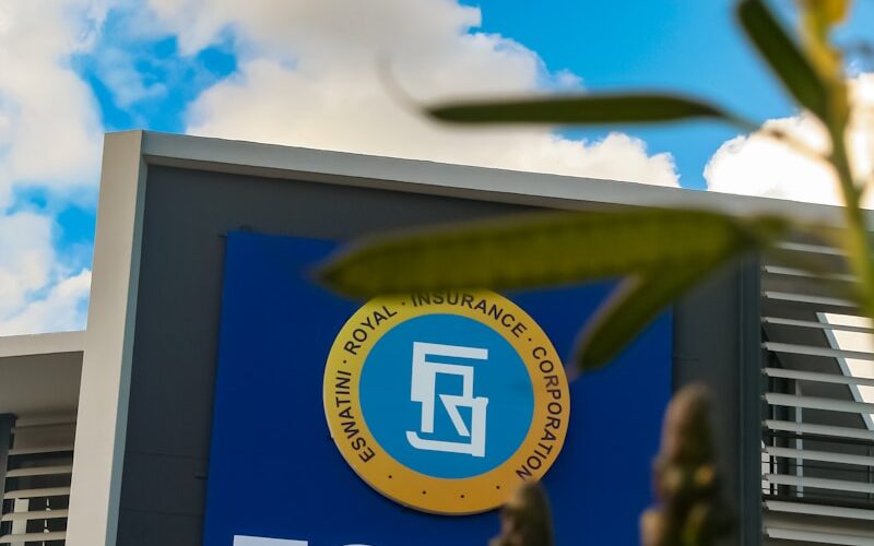 Flowers frame the esprc building under a blue sky.